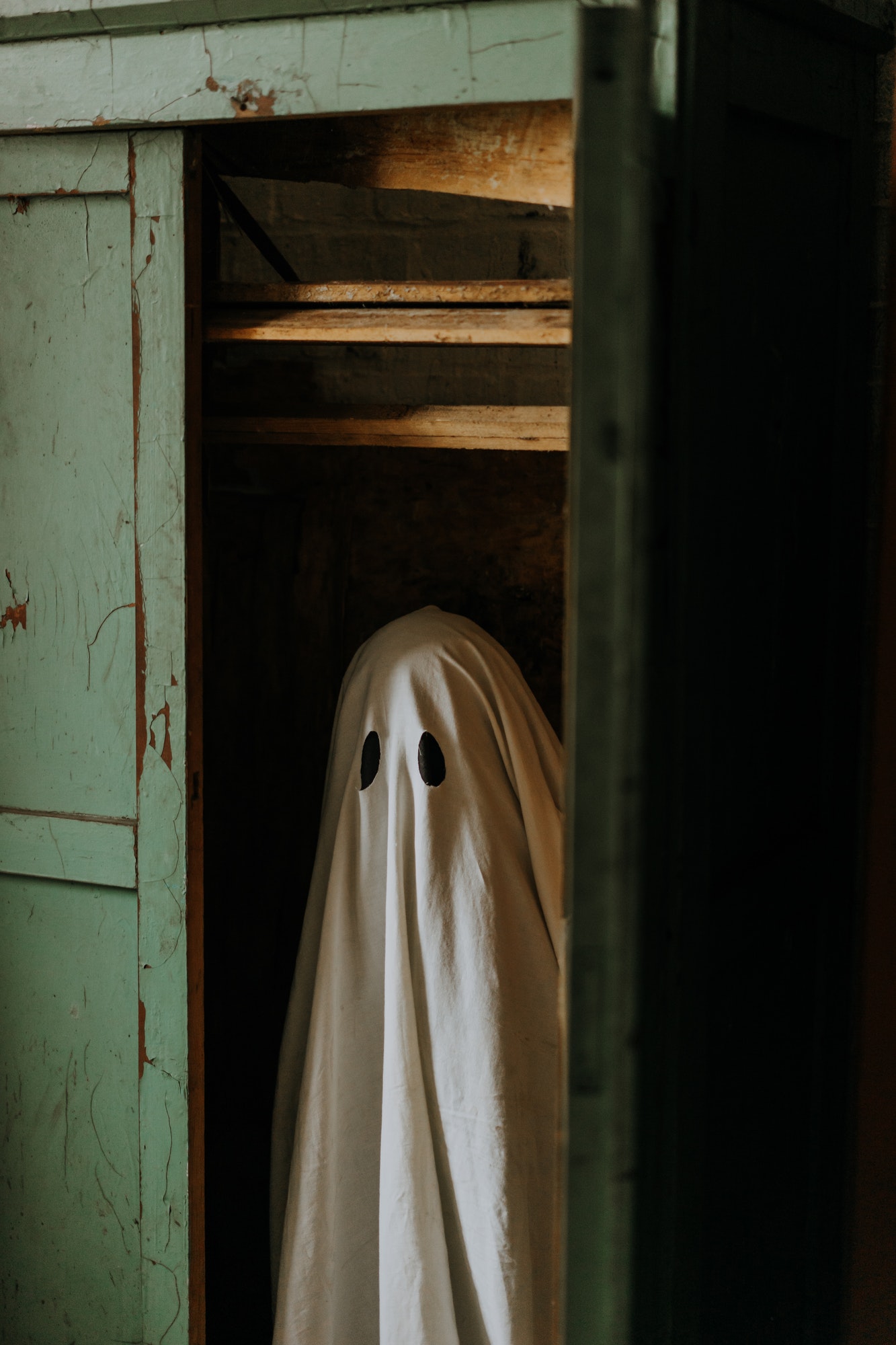 little ghost standing in the closet autumn halloween.jpg